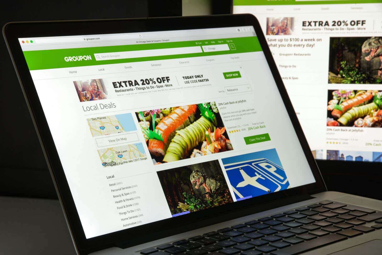 The Groupon website displayed on a laptop by Casimiro PT via Shutterstock